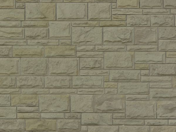 Straight beige stone in different sizes set evenly in wall.
